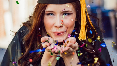 woman blowing assorted color confettis by Logan Isbell (https://unsplash.com/@loganisbell)