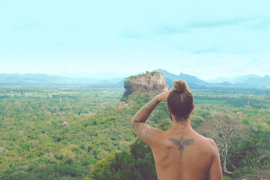 man sight seeing on mountain in Pidurangala Rock Sri Lanka