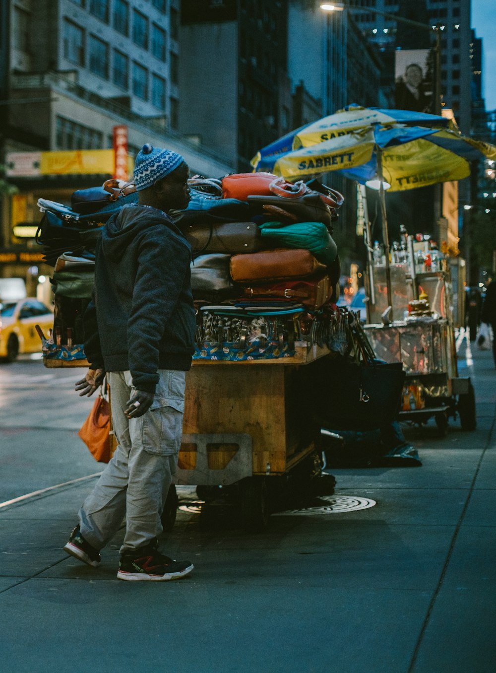 man standing beside brown stal at nighttime