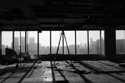 A team finishing up a post-construction cleaning in a bright, empty room.