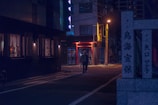 A quiet street at dusk with glowing street lamps and a lone figure walking thoughtfully.