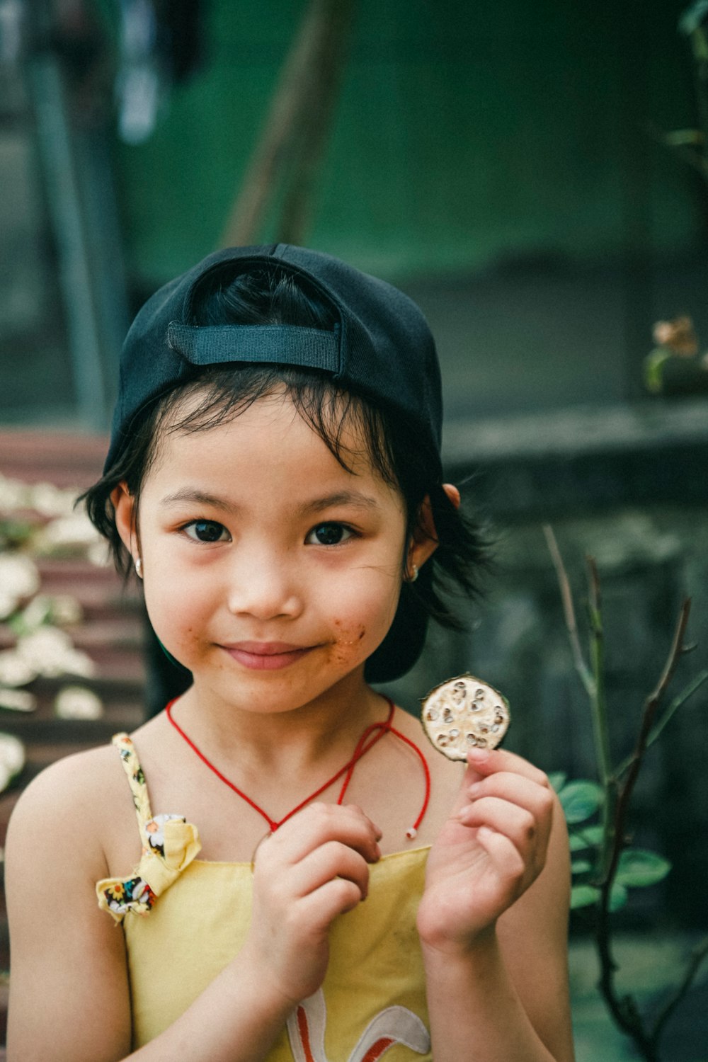portrait photography of girl holding round coin