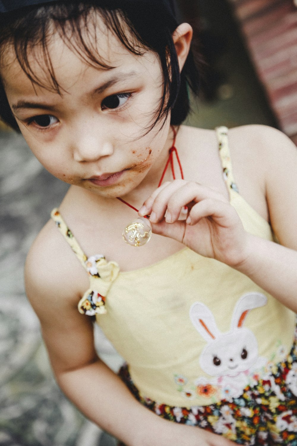 girl holding necklace