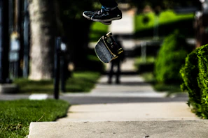 A sleek professional shortboard slicing through urban pavement with a rider mid-trick.