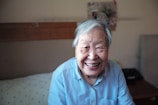 woman in blue button-down shirt smiling in front of camera