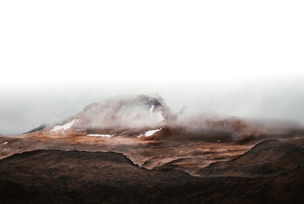 fog above brown land formation during daytime