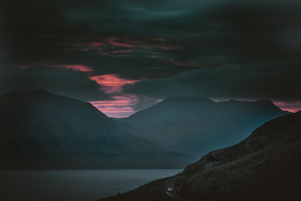 body of water between mountains photo