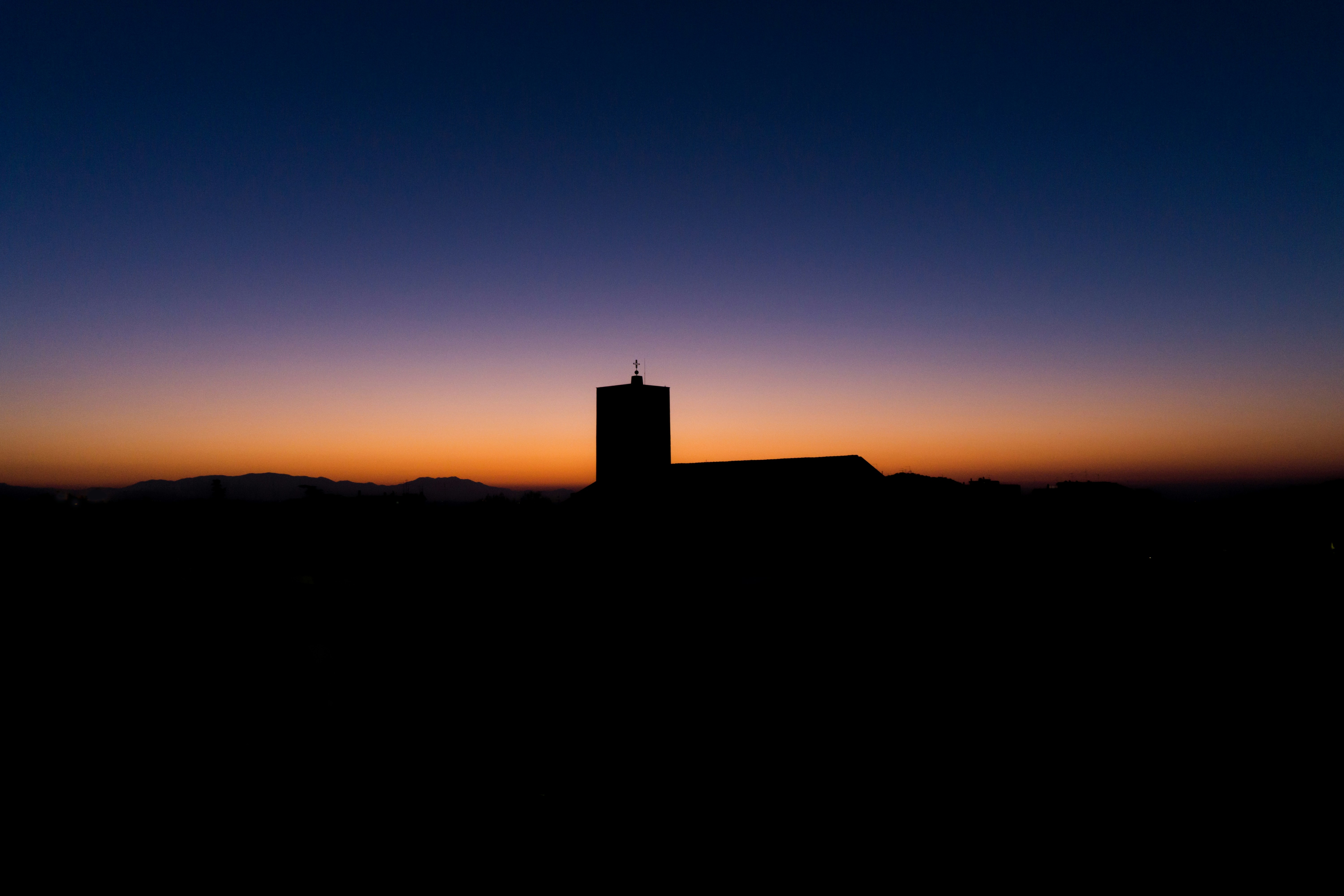 silhouette of building during golden hour