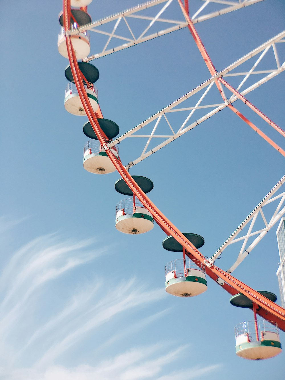 white and blue metal ferris wheel in closeup photography