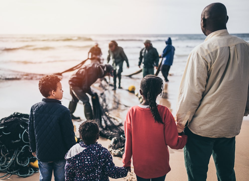 group of people standing on seashore