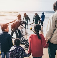 group of people standing on seashore