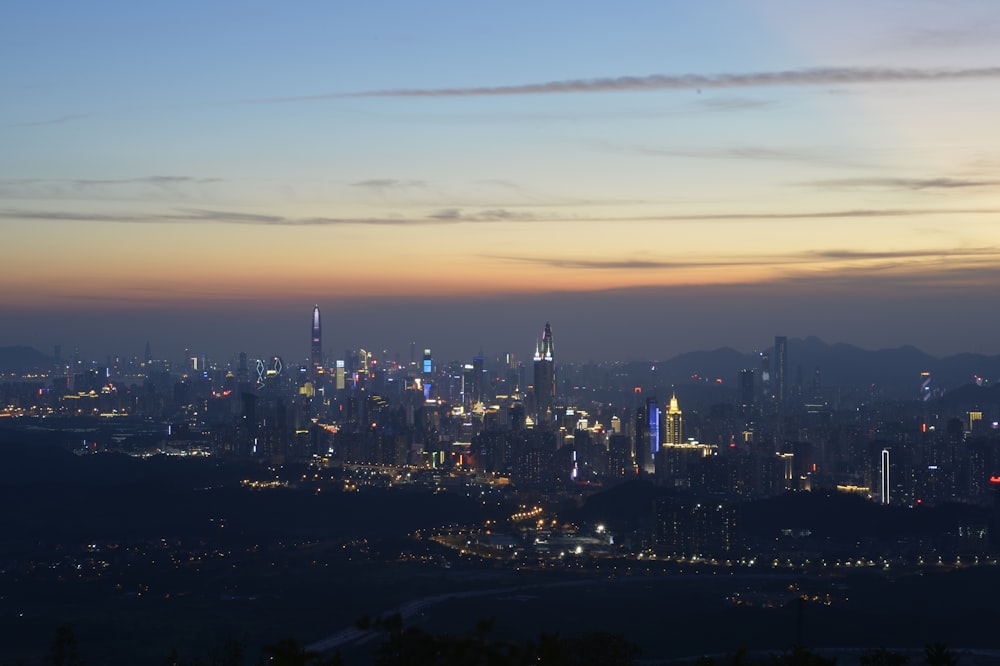 a view of a city at night from the top of a hill