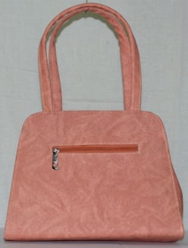 A stylish diaper bag in soft pink, perfect for on-the-go moms.