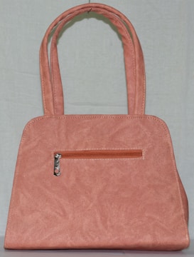 Photo of a minimalistic handmade purse in soft pastel mint colors.