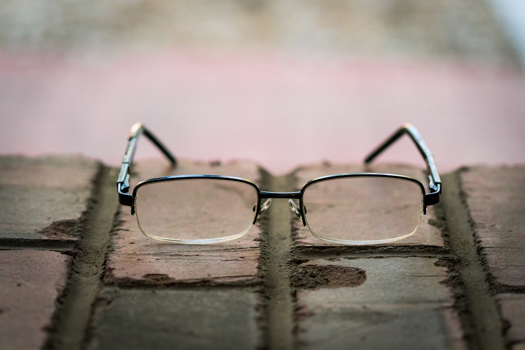shallow focus photo of eyeglasses with silver frames