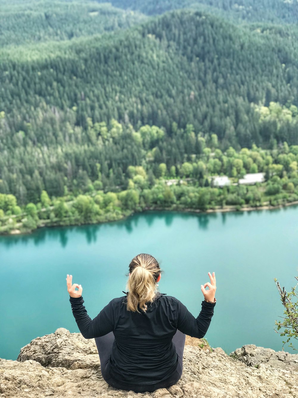 woman sitting on mountain edge