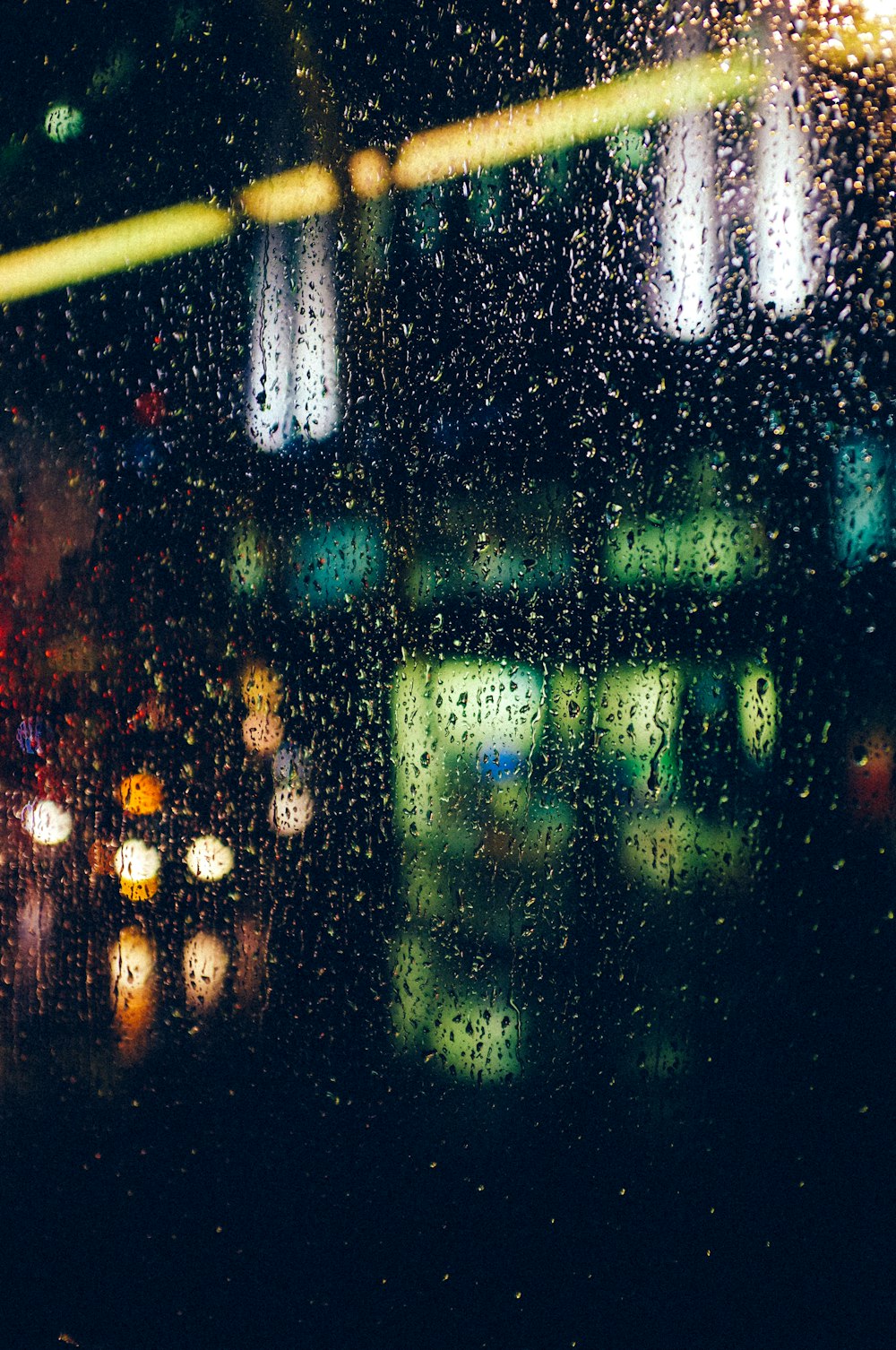 bokeh photography of water dew on window