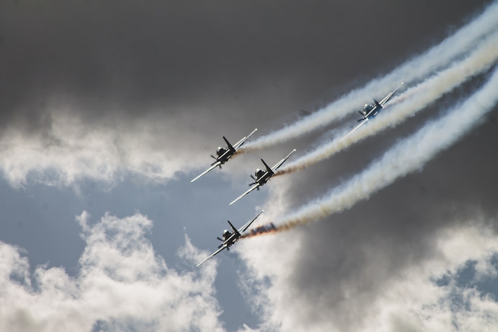 four black planes flying in sky