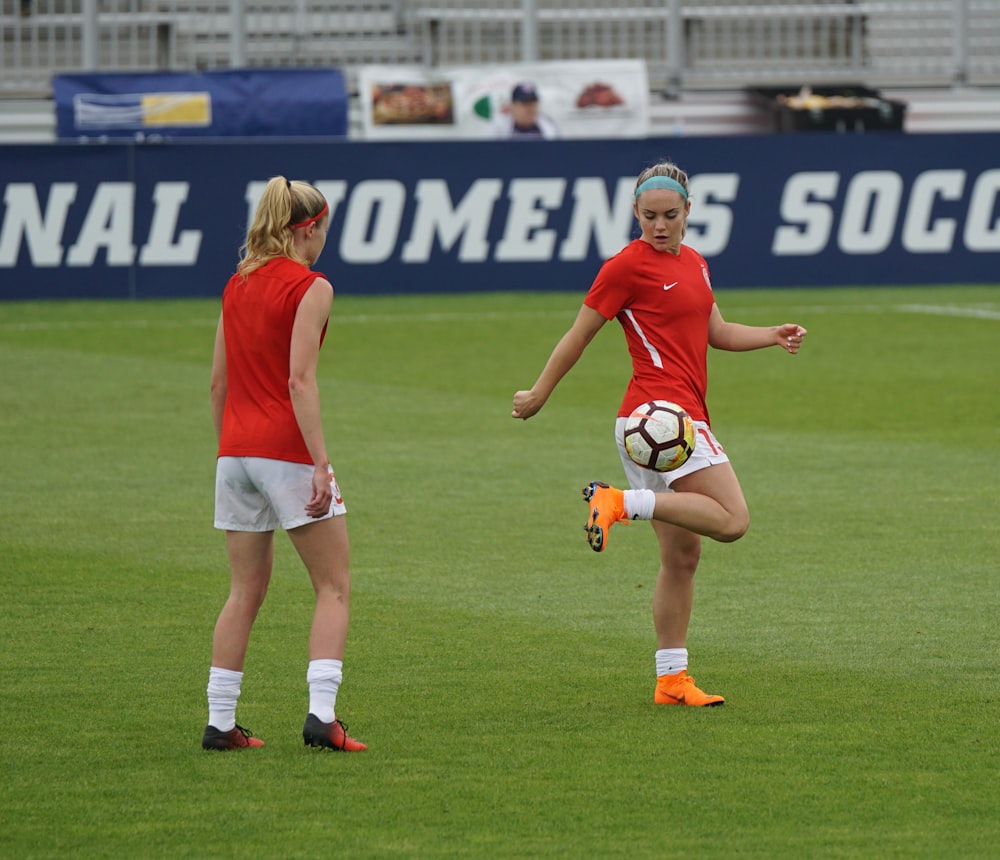 two women playing soccer