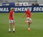 two women playing soccer