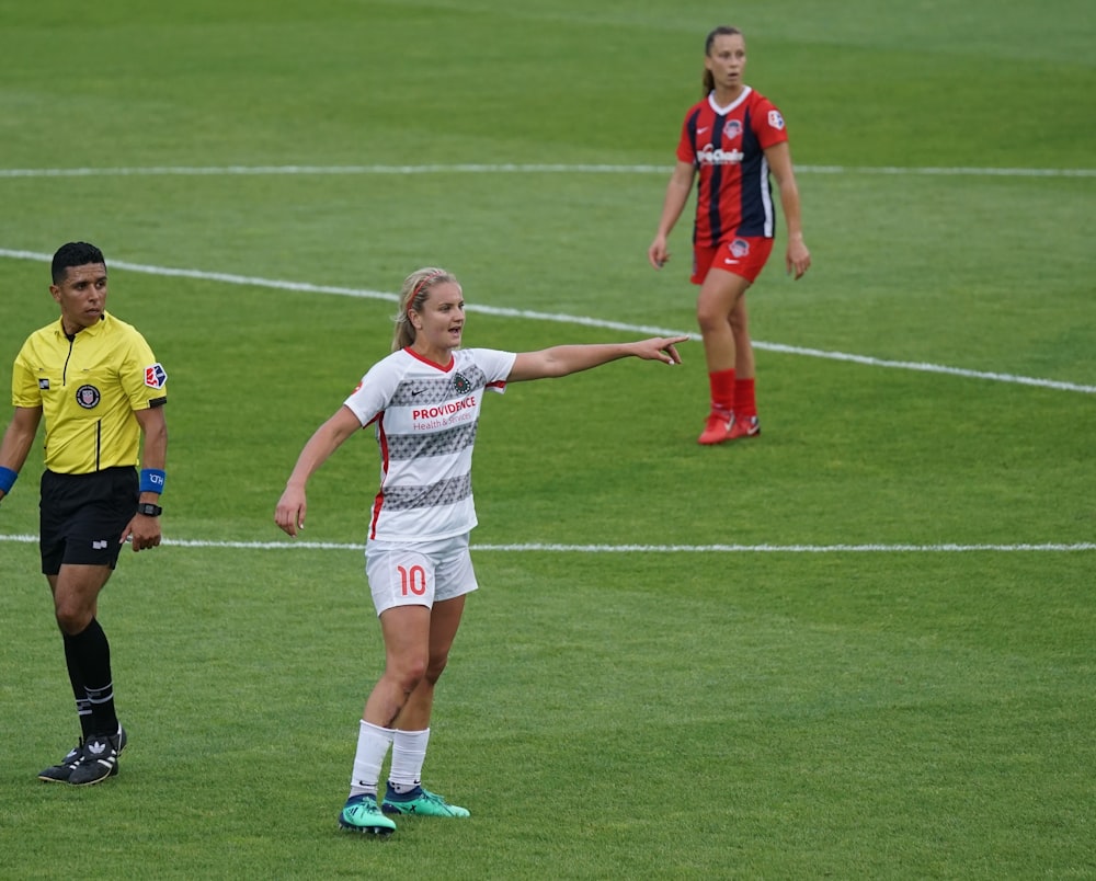 women playing soccer during daytime