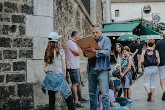 man holding clipboard talking to girl