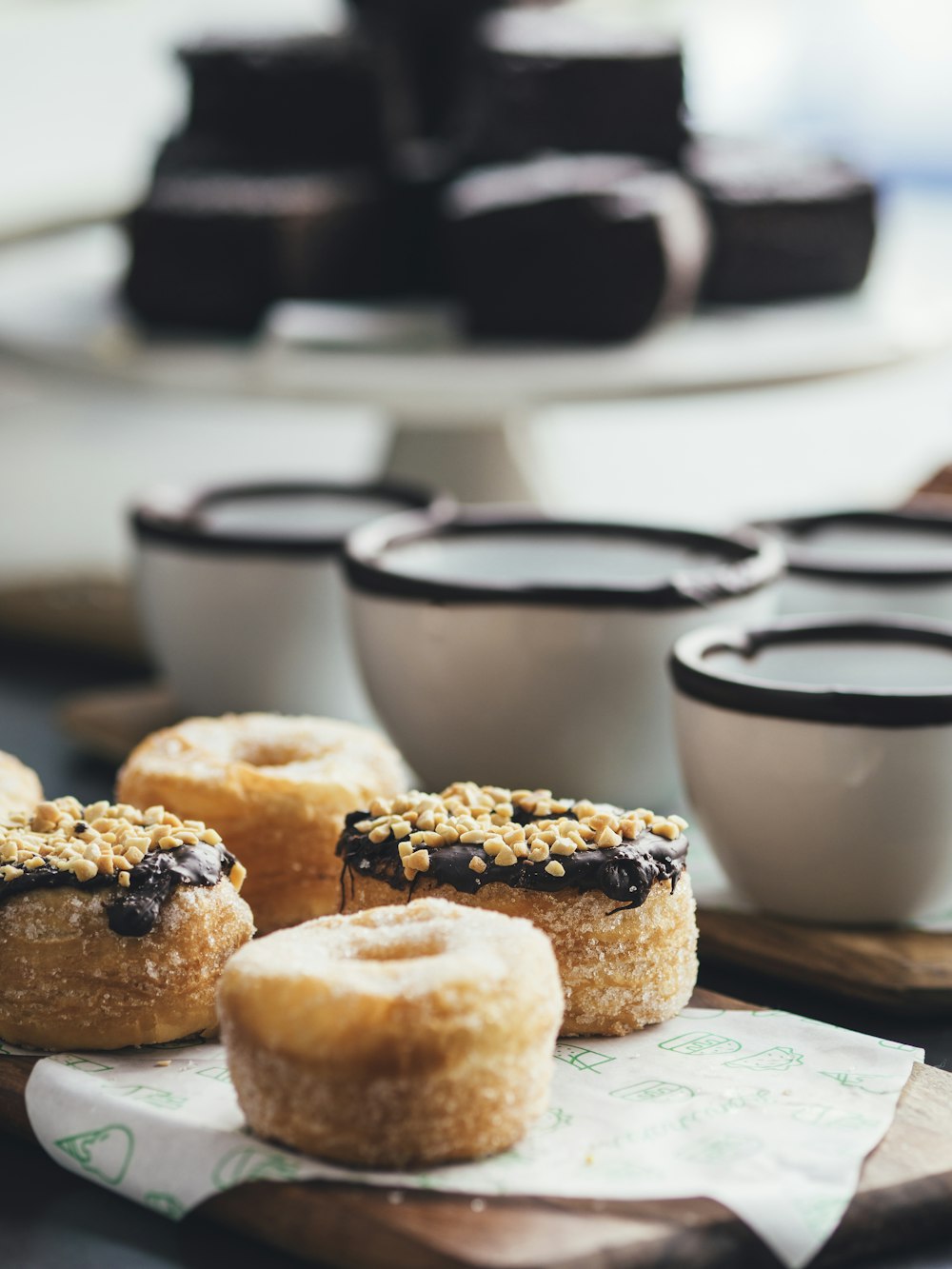 doughnuts topped with chocolate and peanuts selective focus photography