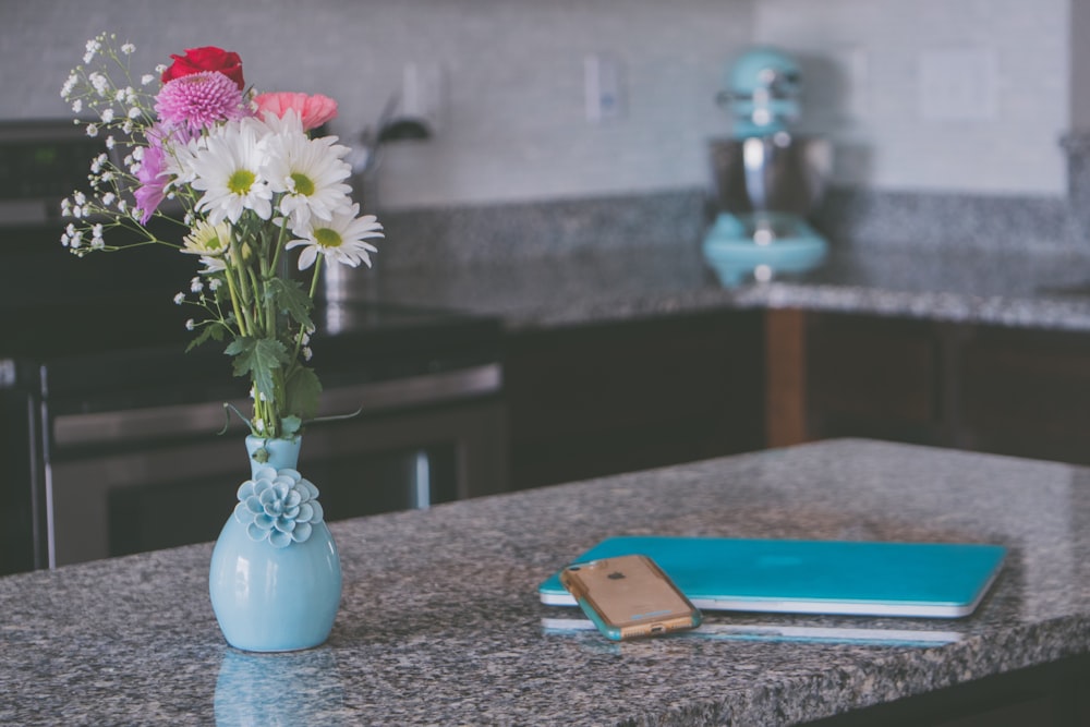 white, purple, and red flowers on gray ceramic vase