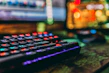 Close-up of a colorful mechanical keyboard with glowing backlit keys.