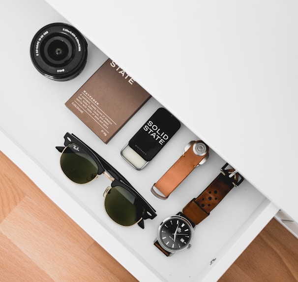 black framed Ray-Ban sunglasses on white drawer