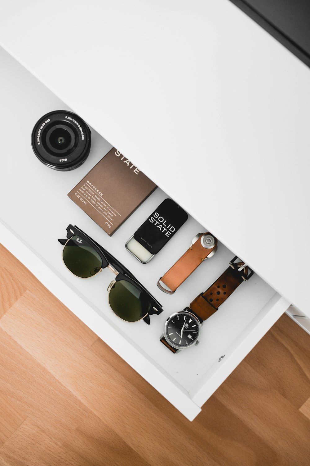 black framed Ray-Ban sunglasses on white drawer