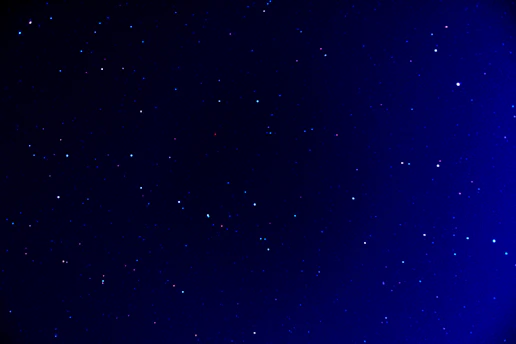 A serene view of a deep navy night sky scattered with muted gold fine-line constellations, evoking calm reflection.