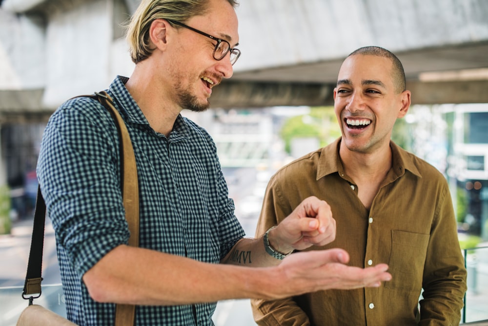 two men having conversation while walking