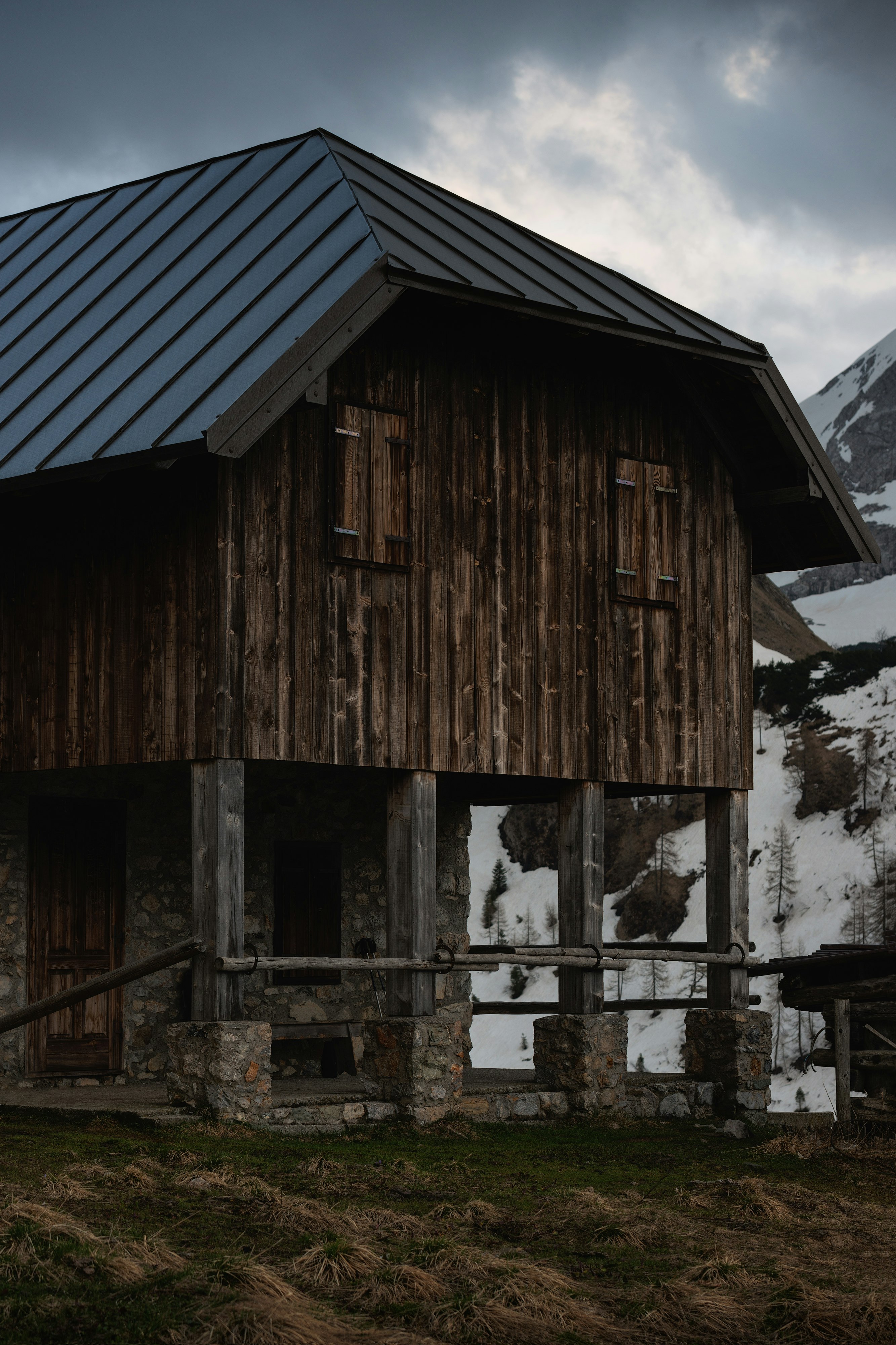 brown wooden house near mountain