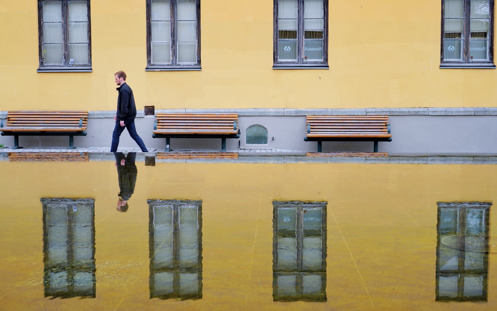 mirror photography of man waking on street