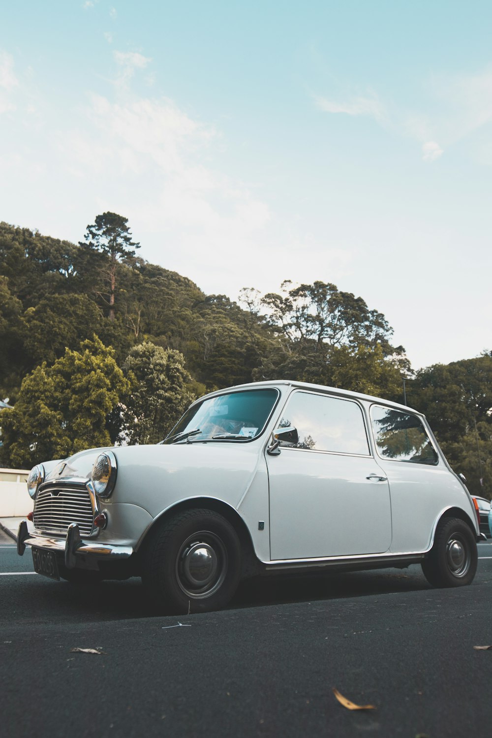 white classic car travelling on the road