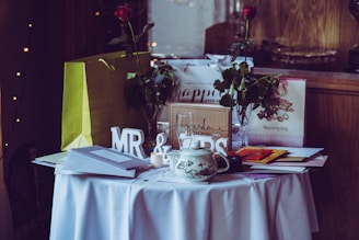 two red roses and mr. & mrs. free-standing letters on top of table