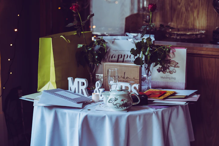 Elegant wedding table setup with roses and gifts