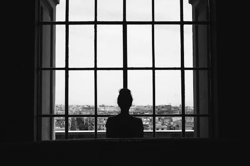 woman standing in front glass window