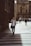 man holding phone while standing on pedestrian lane