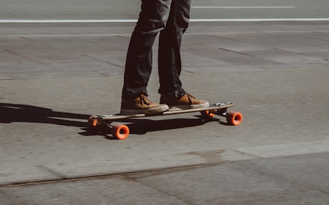 Longboarder cruising on a sunny city road