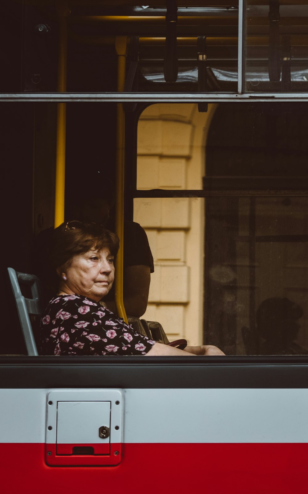 woman sitting inside a white and red vehicle