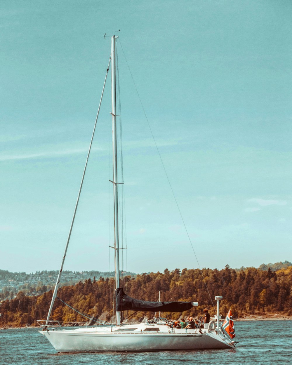 white sail boat on body of water during daytime