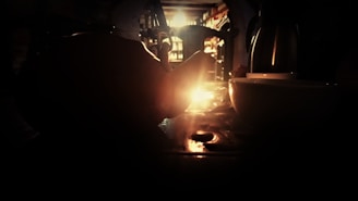 A cozy, warmly lit room with people enjoying tea and conversation.