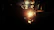 A steaming cup of tea beside a softly glowing lantern wrapped in rope.