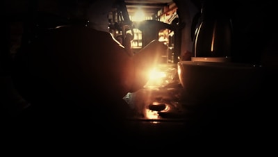 A cozy cup of steaming sleepy-time tea resting on a wooden table beside a softly glowing candle.