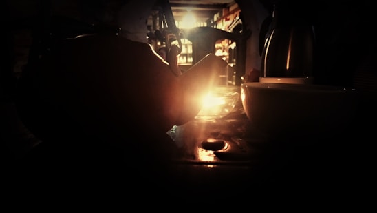 A cozy, warmly lit room with people enjoying tea and conversation.