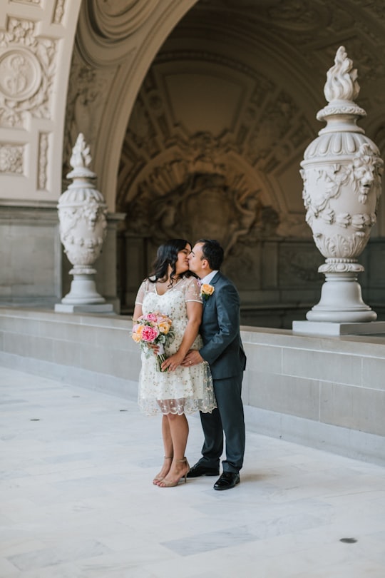 man and woman kissing in San Francisco City Hall United States