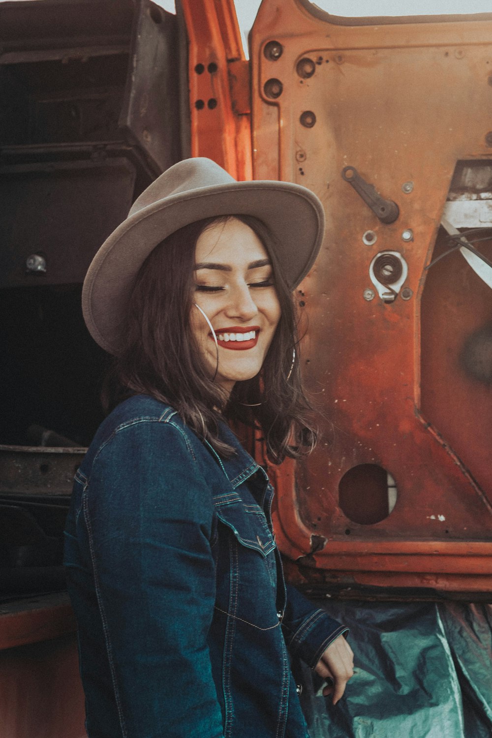 woman smiling beside tractor