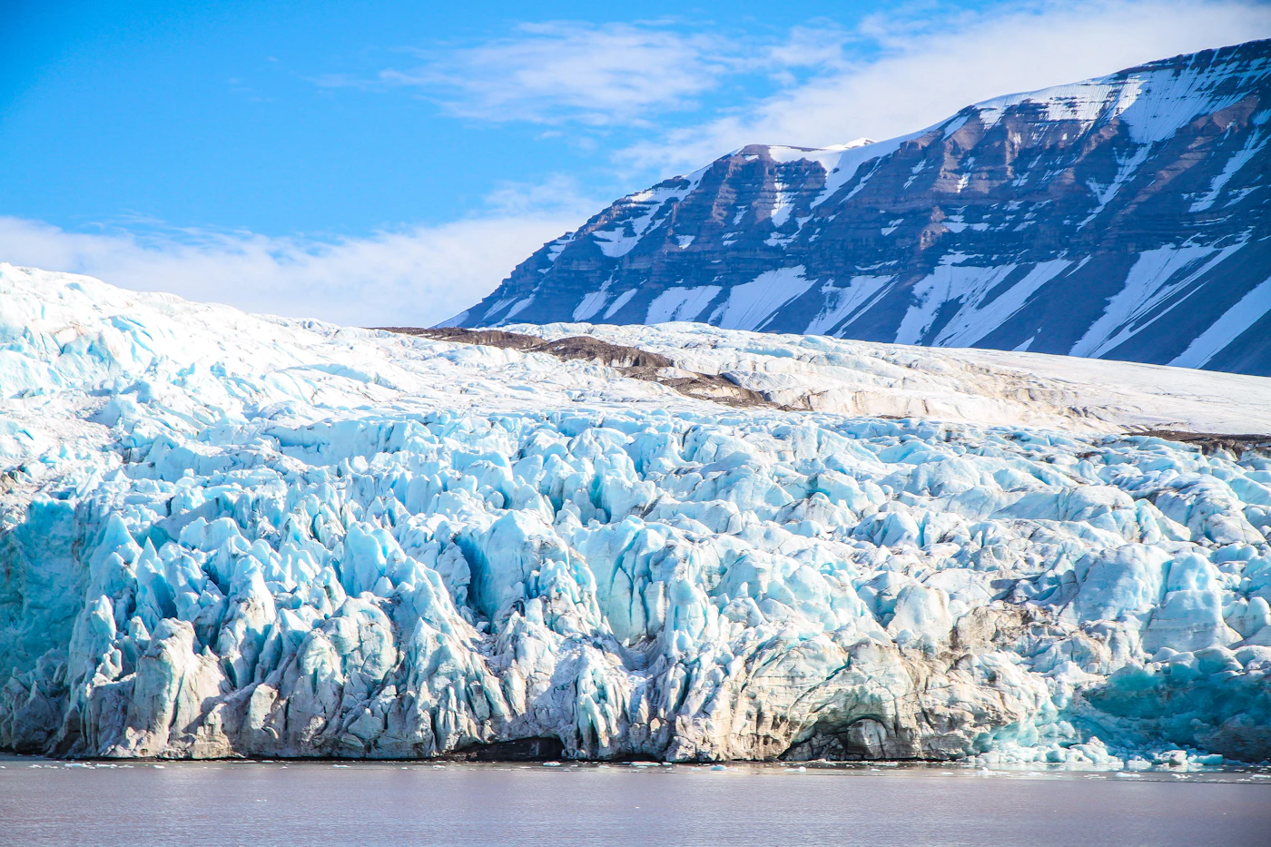 Snow-covered glacier meeting the Arctic sea in Svalbard
